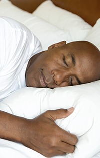 Man sleeping deeply in bed