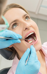 Woman in dental chair being examined