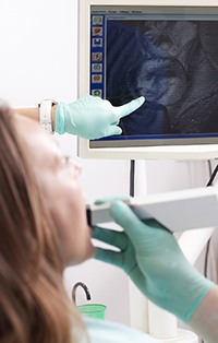 Woman and dentist look at intraoral photos on monitor