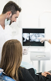 Patient and dentist examine panoramic dental x-rays