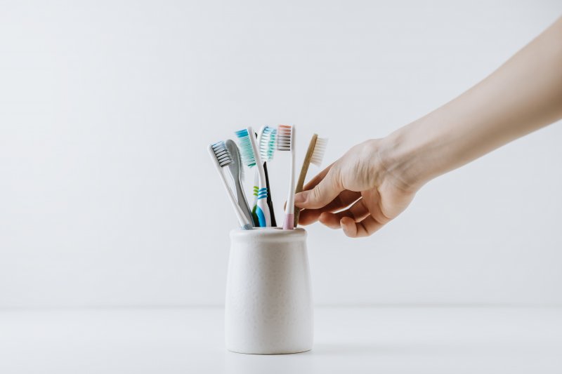 A toothbrush holder with multiple toothbrushes in it